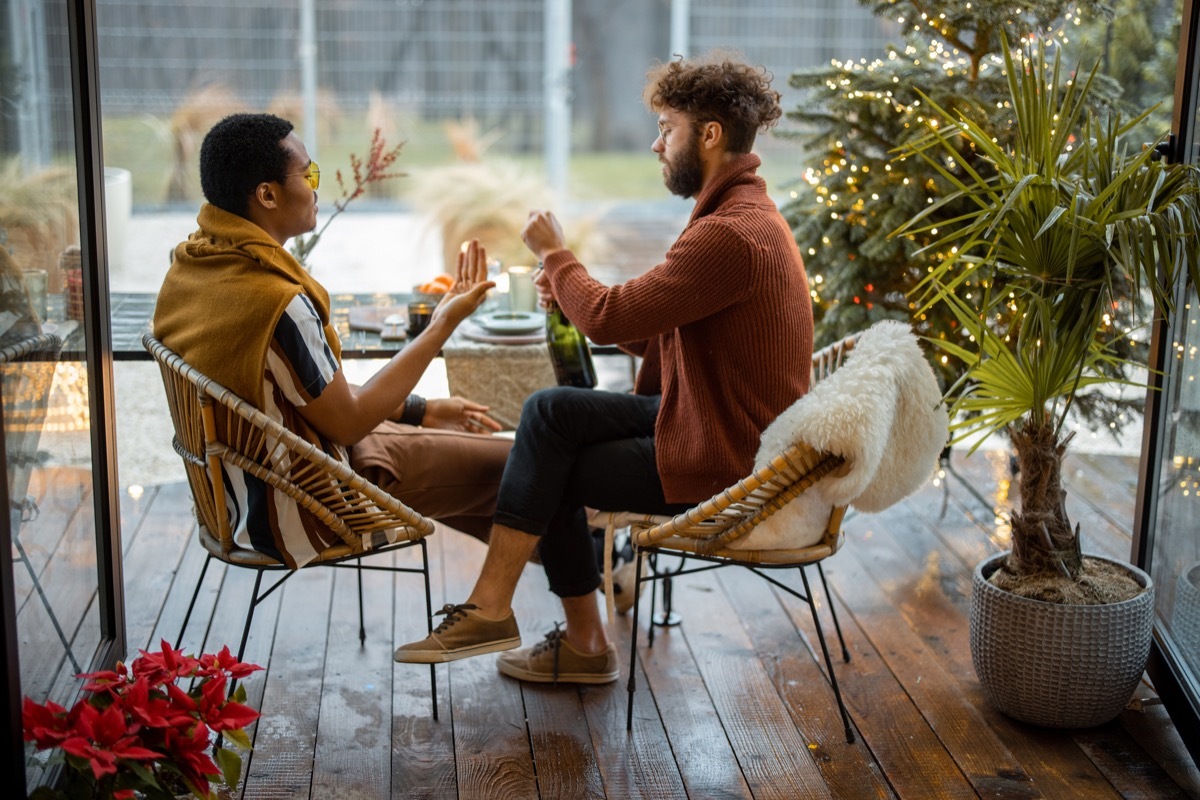 Two male friends drinking spakling wine, celebrating