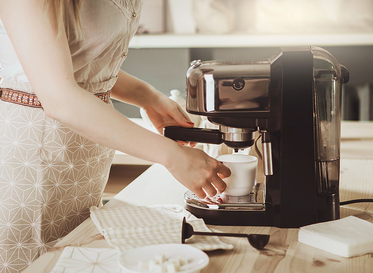 nice dressed woman using coffee machine