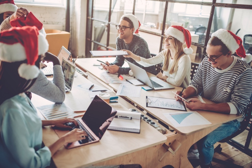 people wearing christmas hats in the office