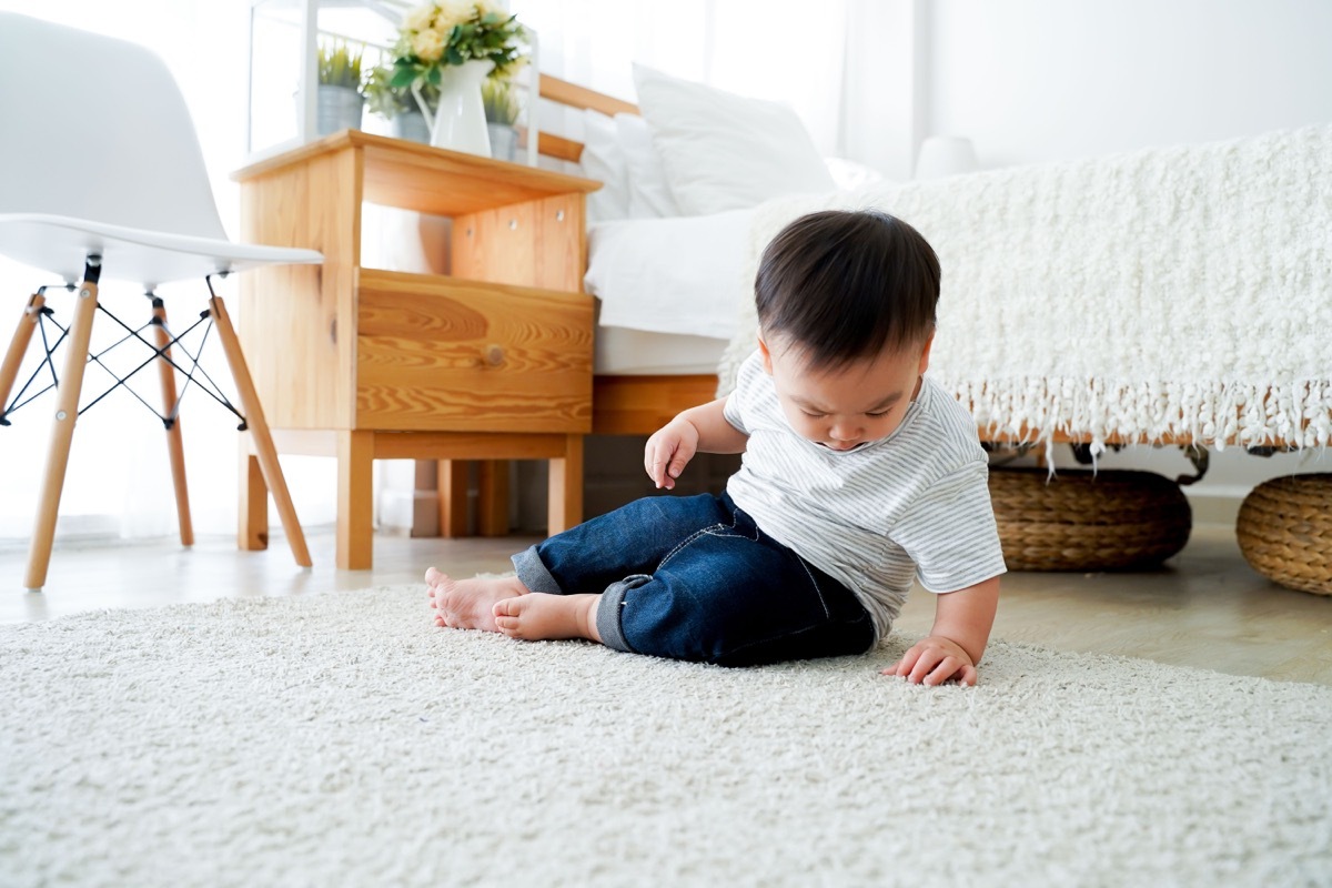 young boy on shag rug