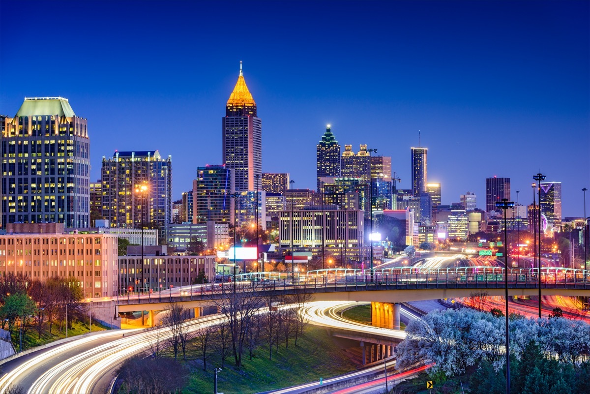 cityscape photo of fast moving traffic on a highway and building in Atlanta, Georgia at night