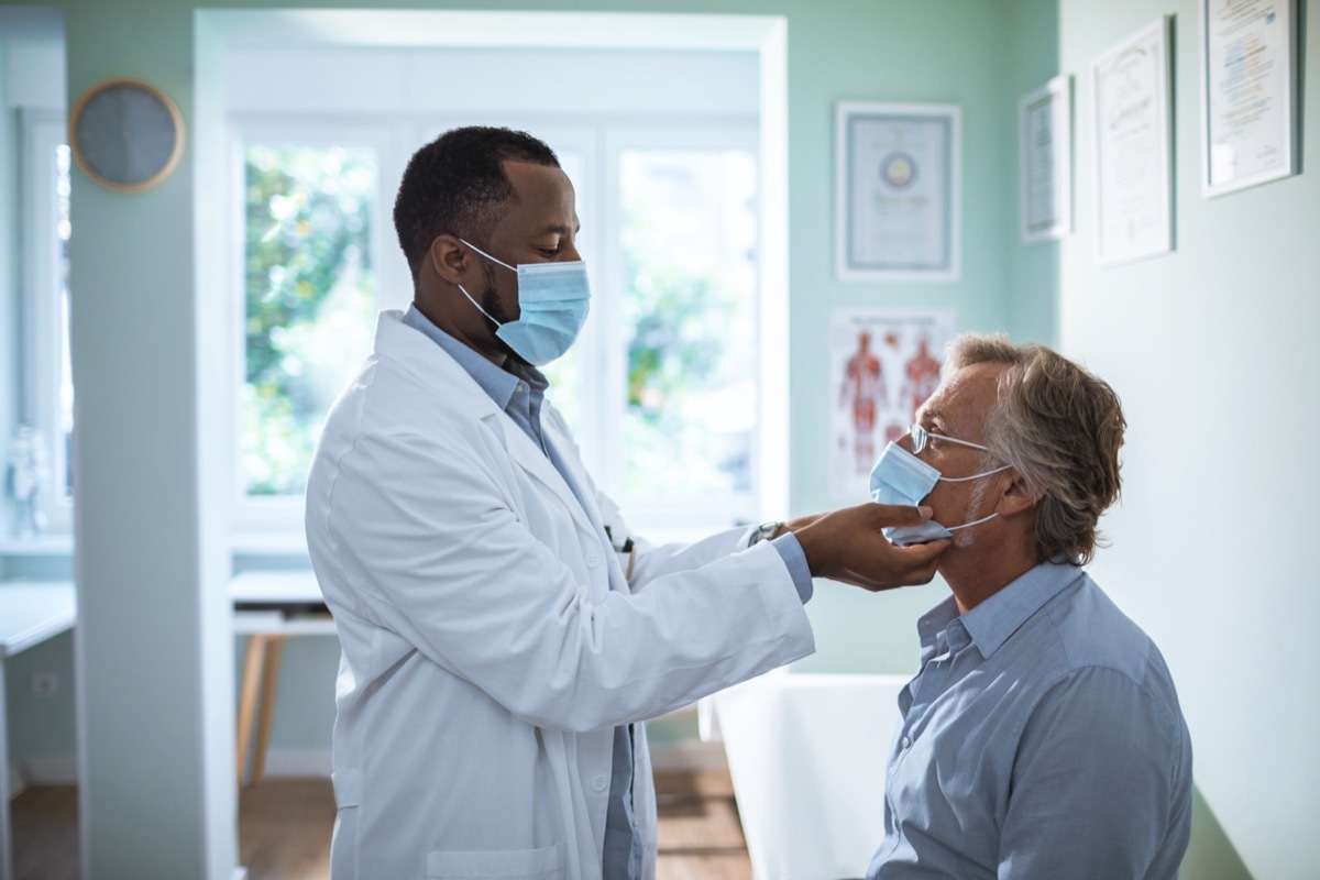 A mature man having a medical exam done in the doctors office.