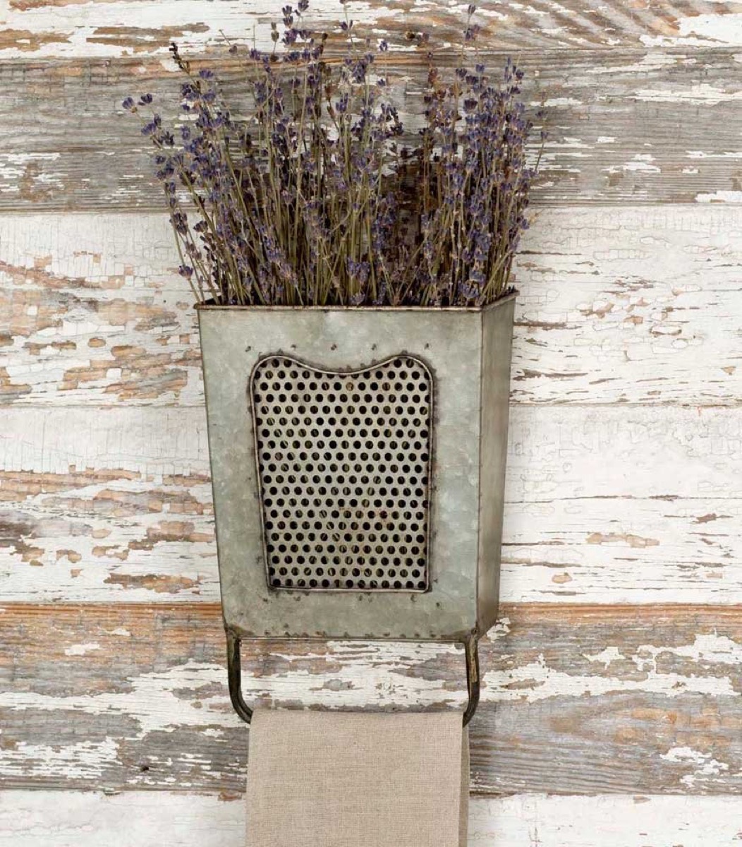 metal bucket with dried flowers on chipped wall, rustic farmhouse decor