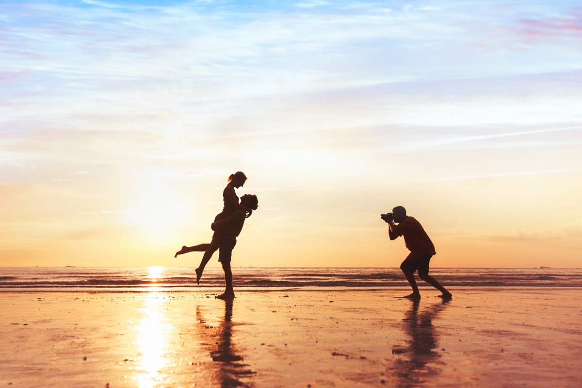 Couple getting their picture taken on the beach