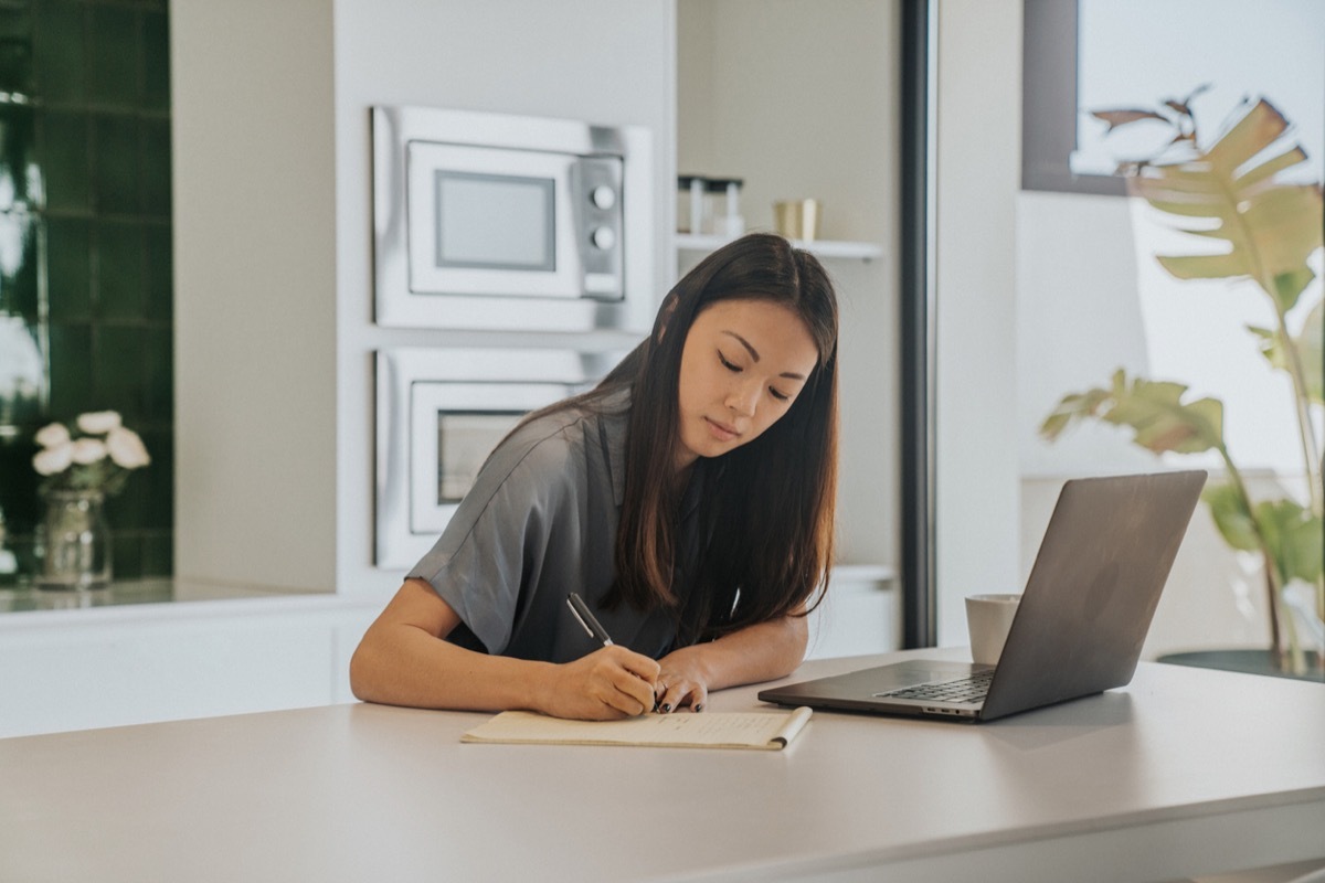 Focused young woman studing from home