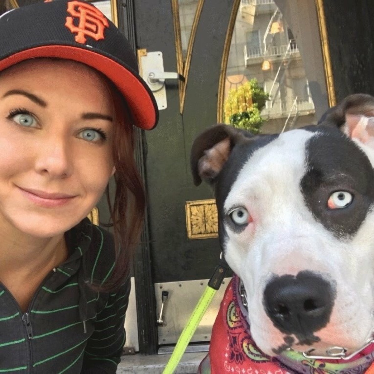 blue eyed woman has same exact eyes as dog, dog and owner twins