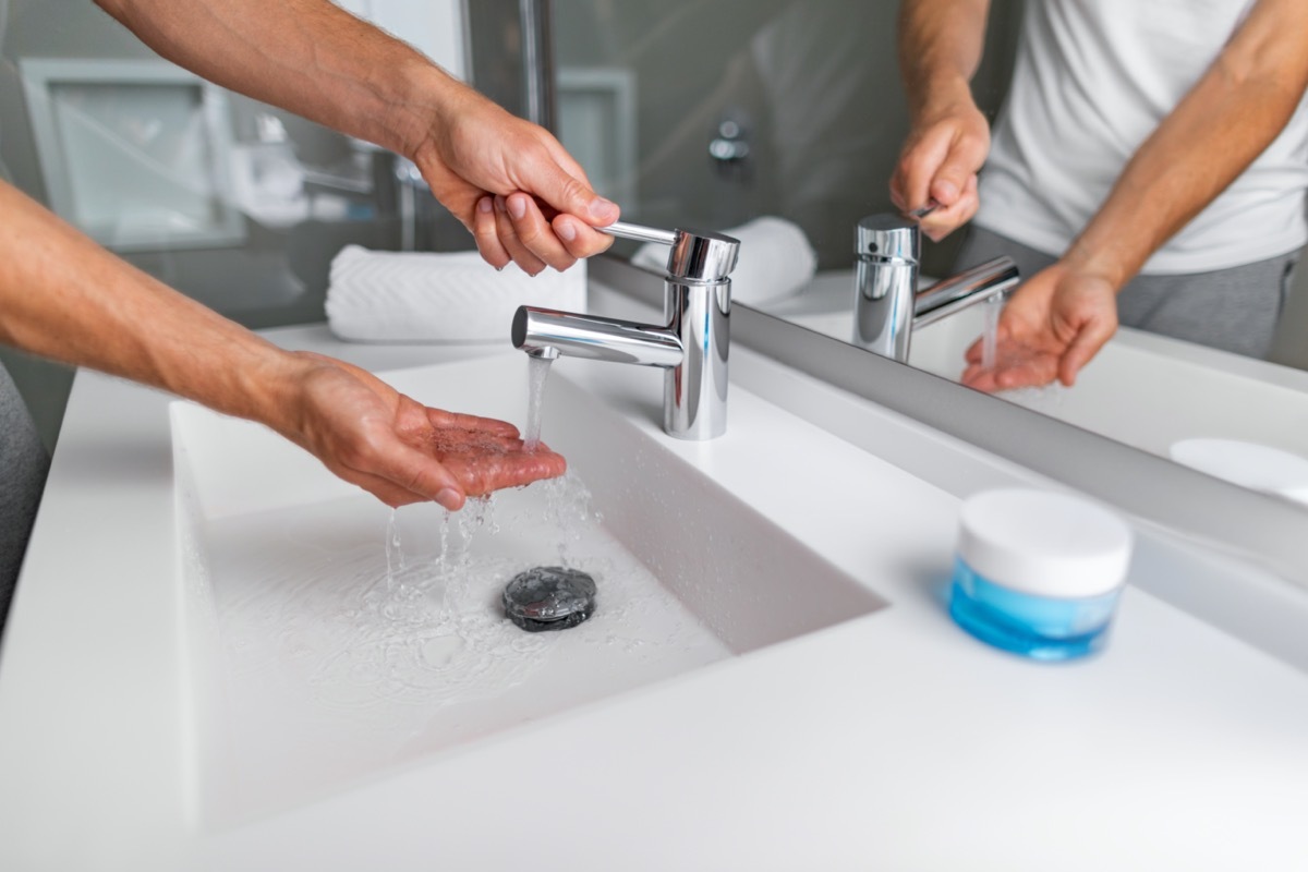 man checking pressure and temperature washing hands