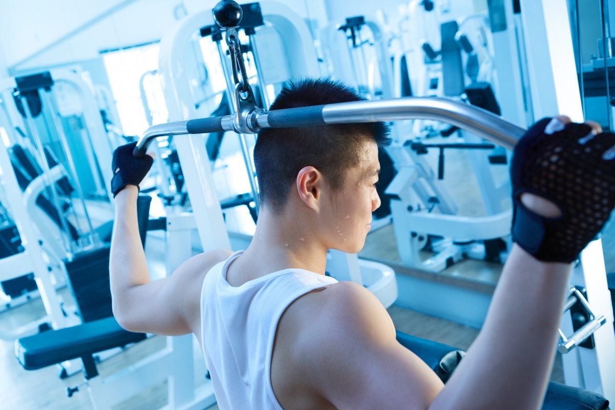 Asian man doing lat pulldowns