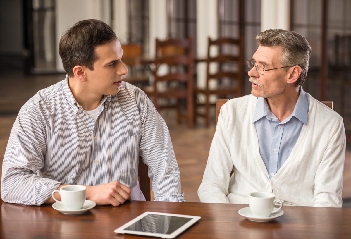 two men talking and hanging out over coffee at a cafe