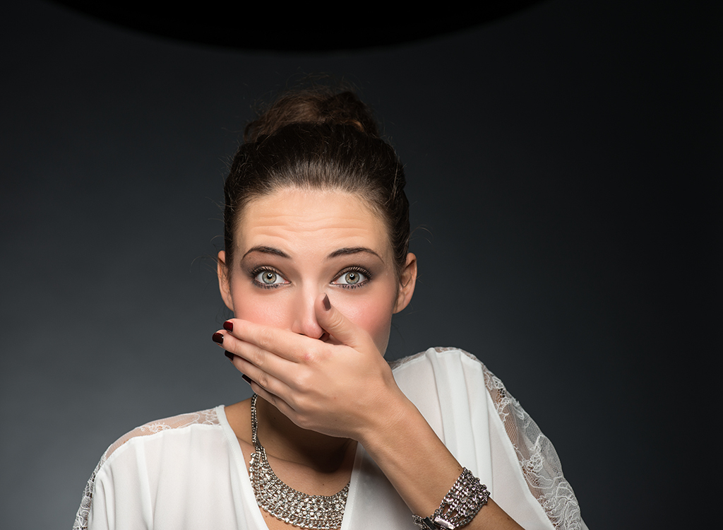 Woman covering mouth