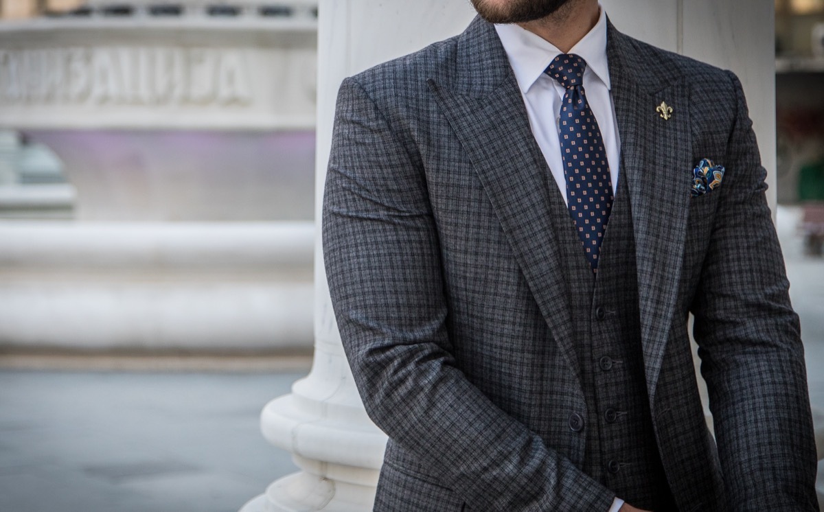 Man in a fitted suit and tie.