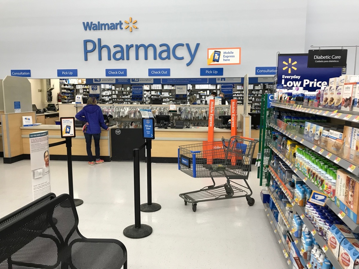 nterior shot of the pharmacy at Walmart. A customer waits for a pickup.