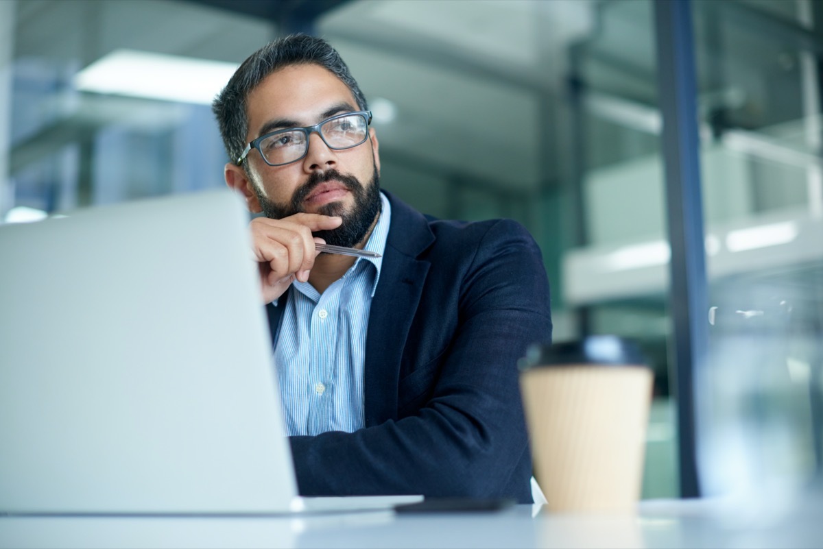 Shot of a mature businessman looking thoughtful while working on a laptop in an office