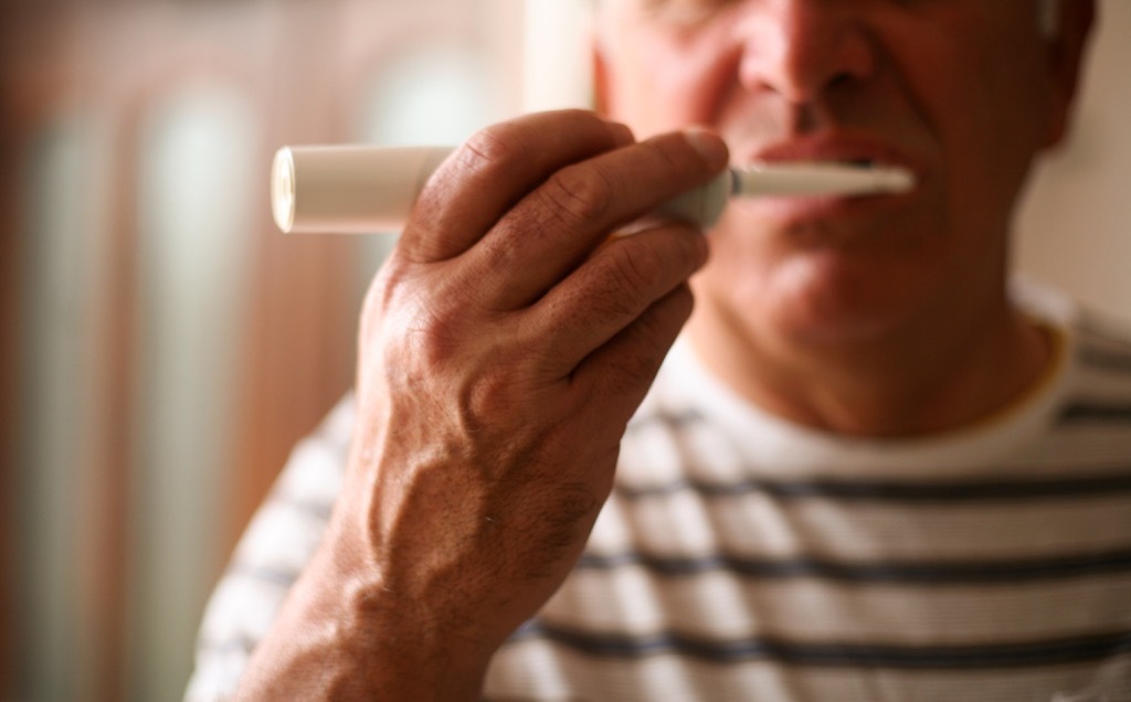 old man brushing teeth