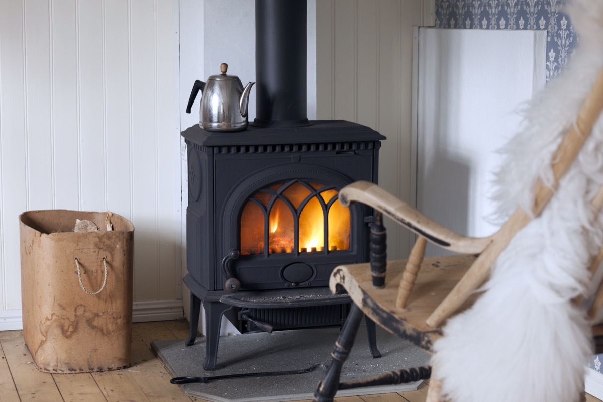 A wood stove next to a rocking chair home hazards