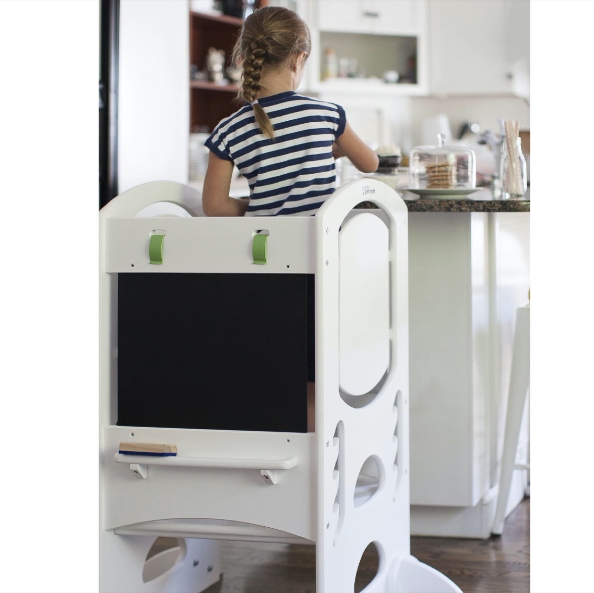 child cooking on white step ladder