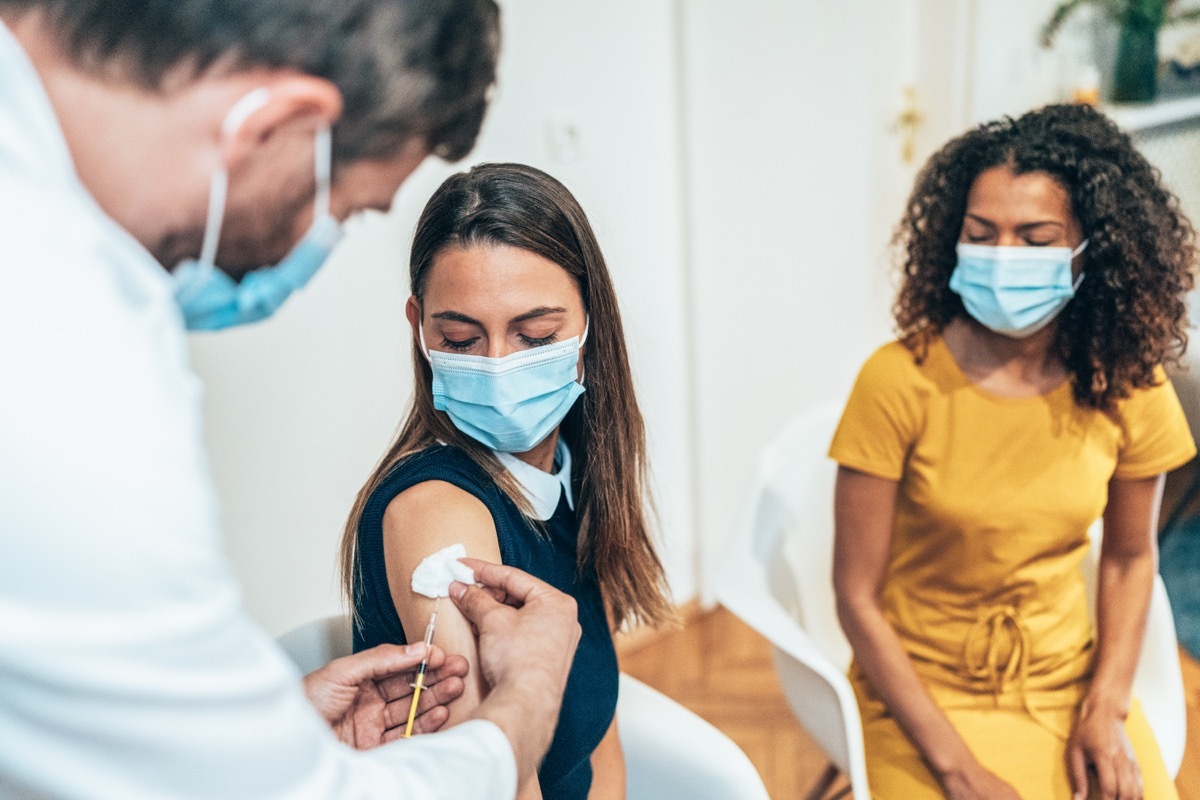 Doctor giving vaccine to woman