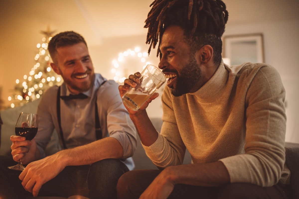 two men telling stories to each other at a holiday party