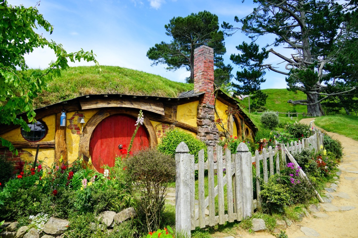 hobbit house in a hillside with a red door