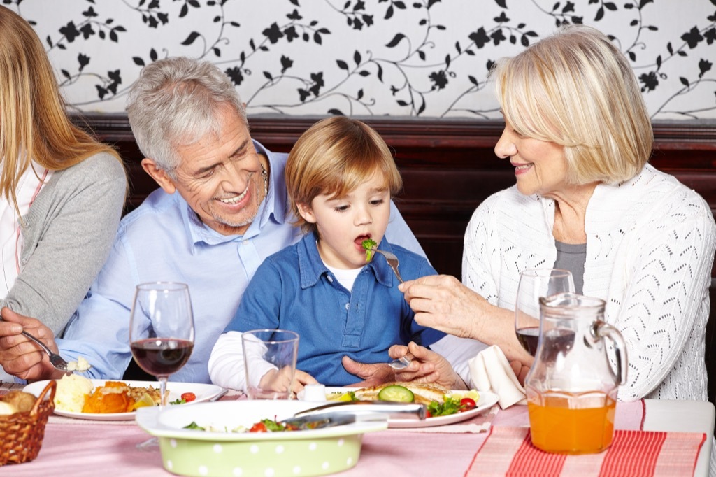 Grandparents eating with their grandchild