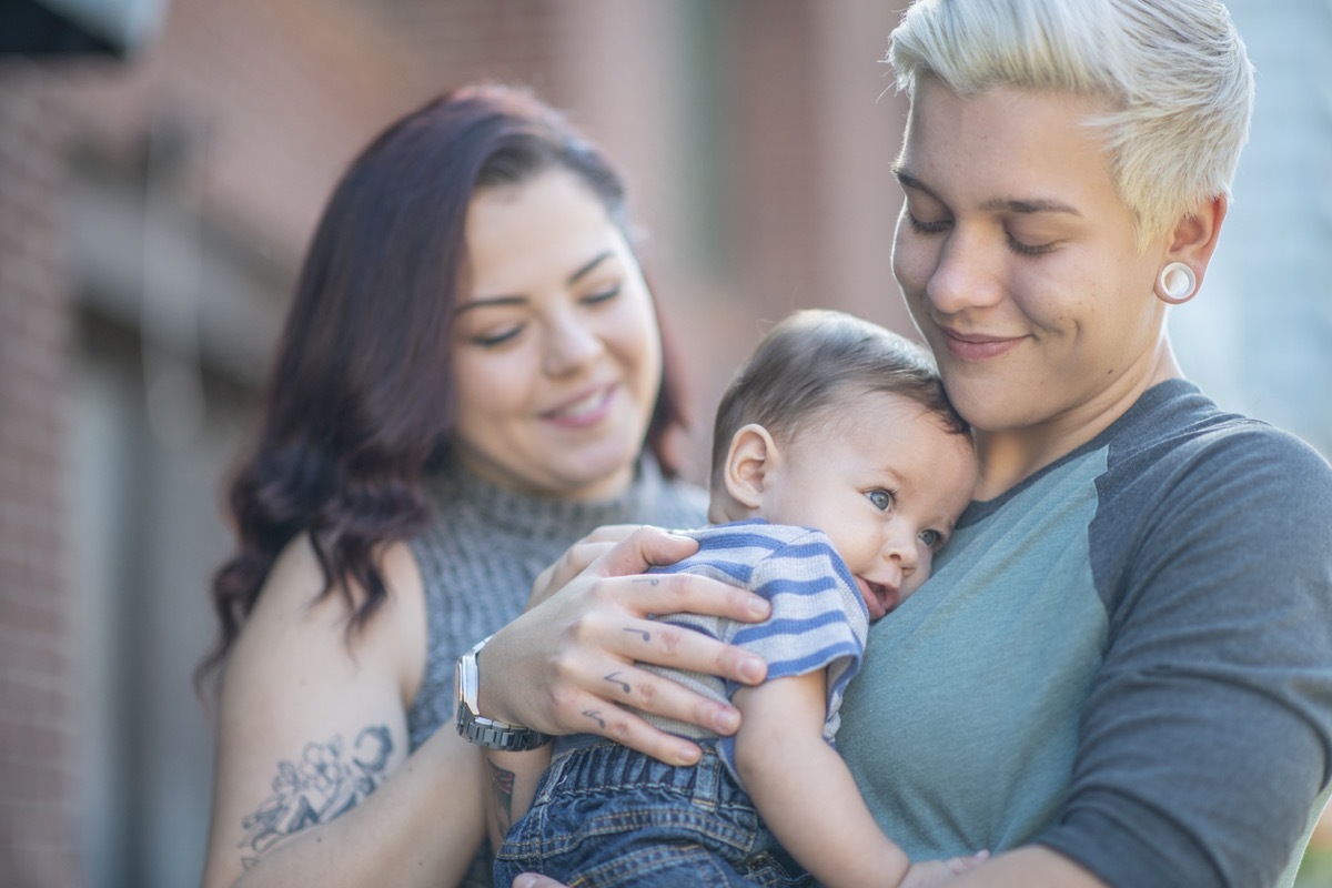 female couple holding their baby