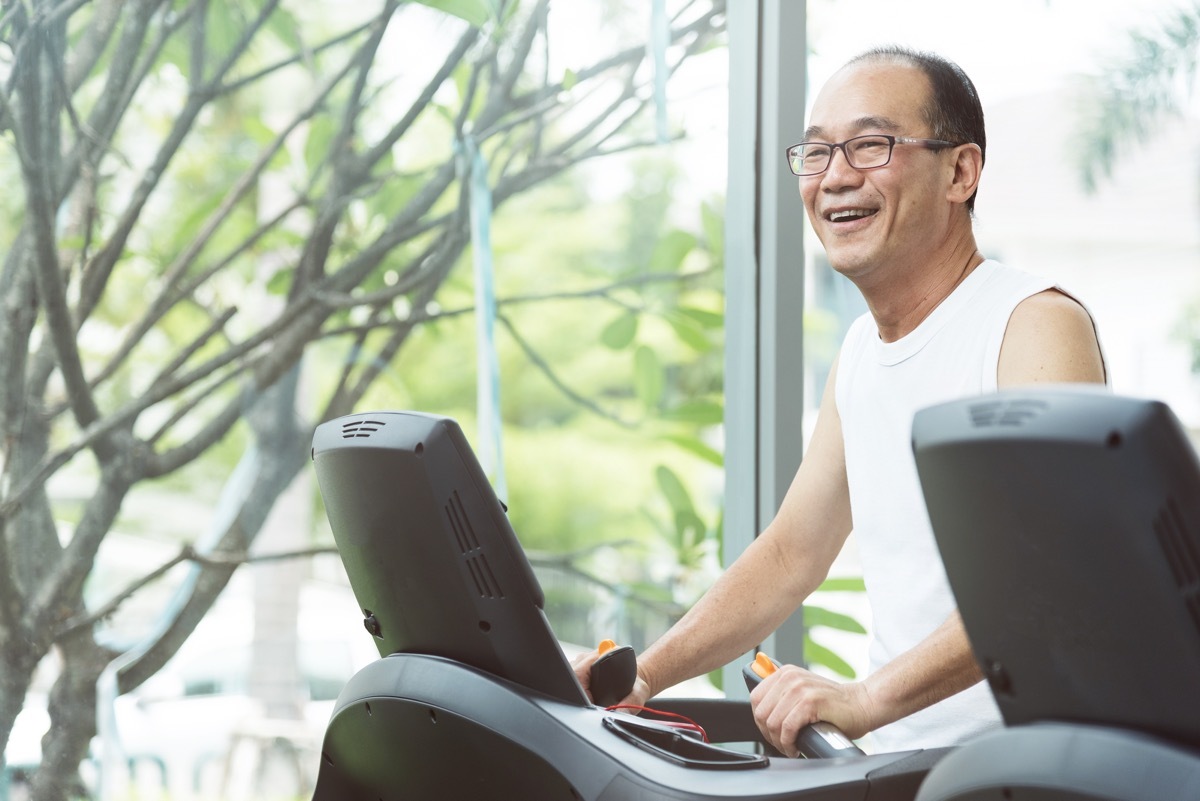 an old man doing warm up exercising on the treadmill