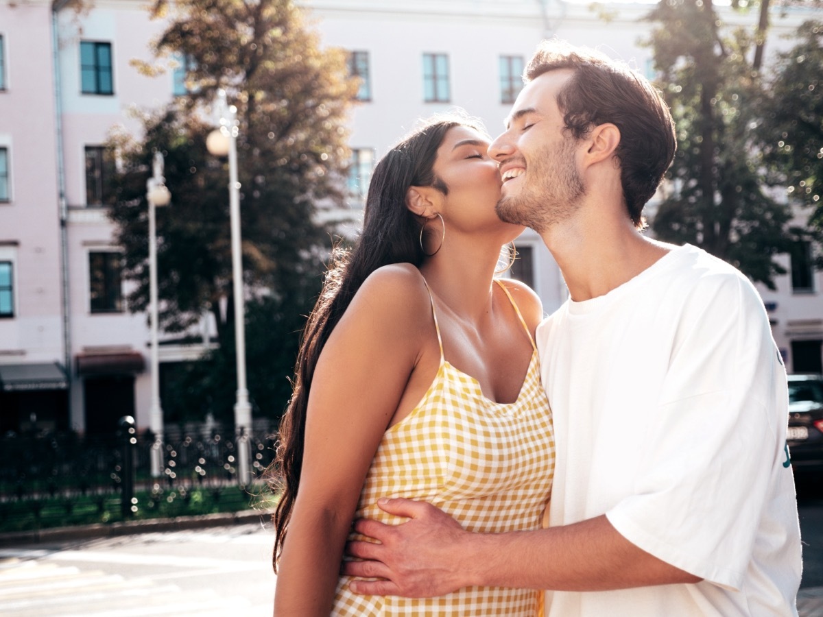 woman smiling while embracing her boyfriend