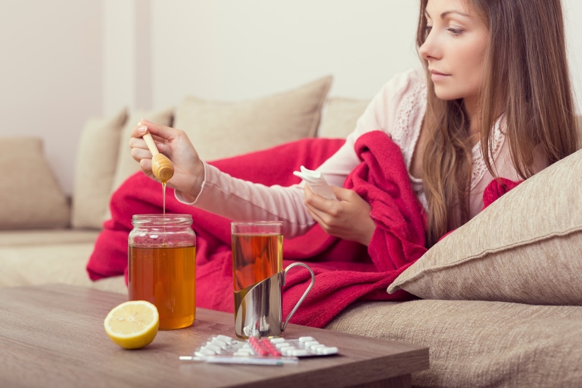 Women using honey to cure cold symptoms