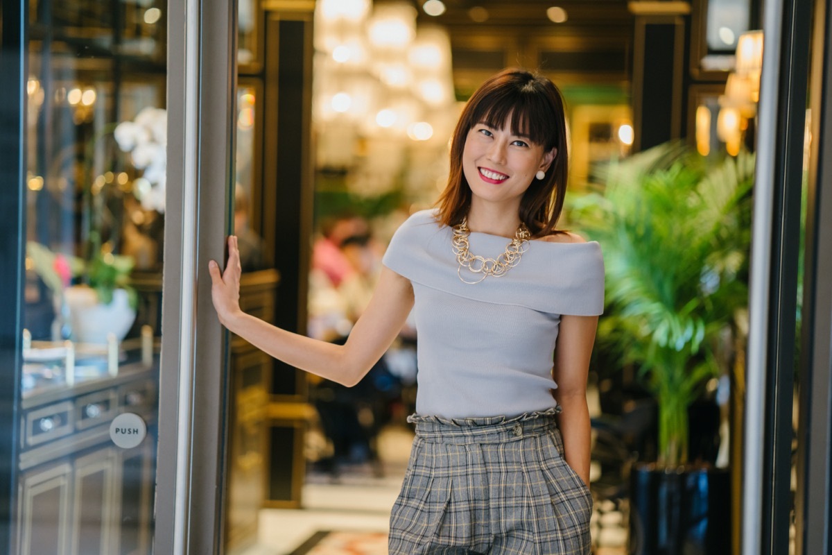 fashionable middle aged asian woman in trendy outfit