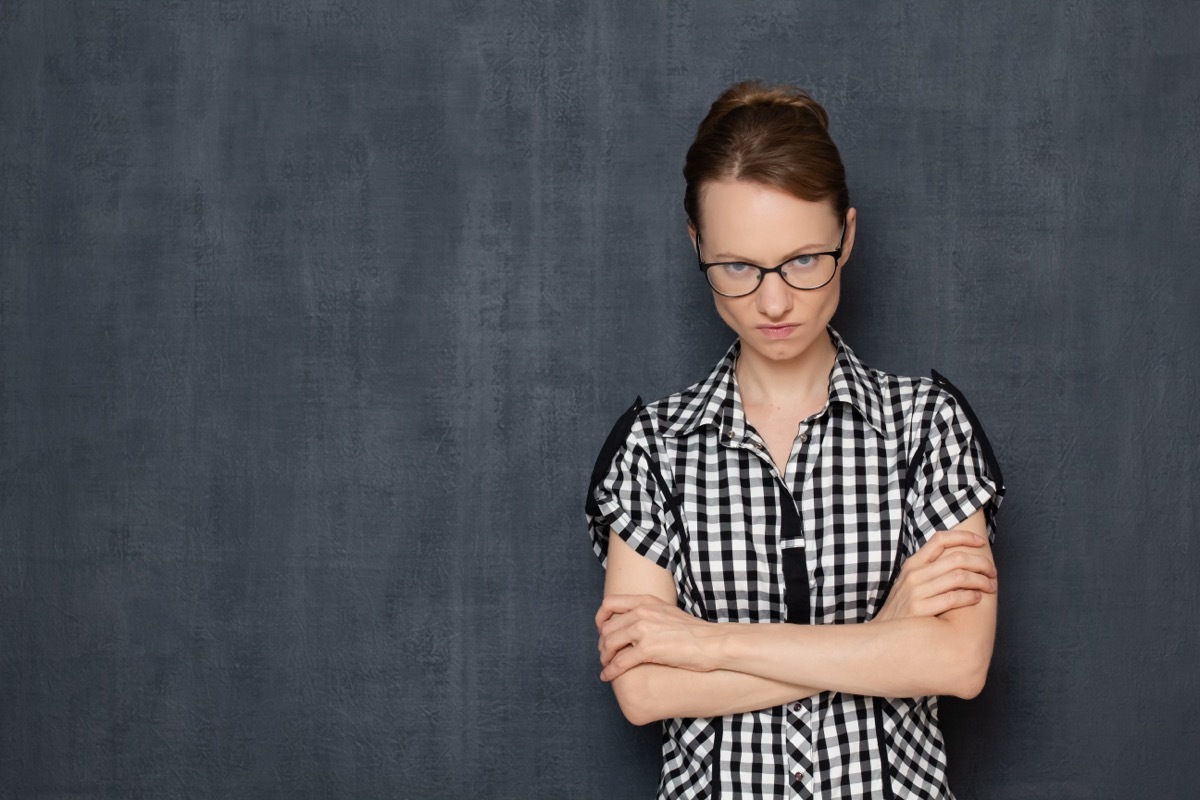 Woman with Arms Crossed and Angry Expression