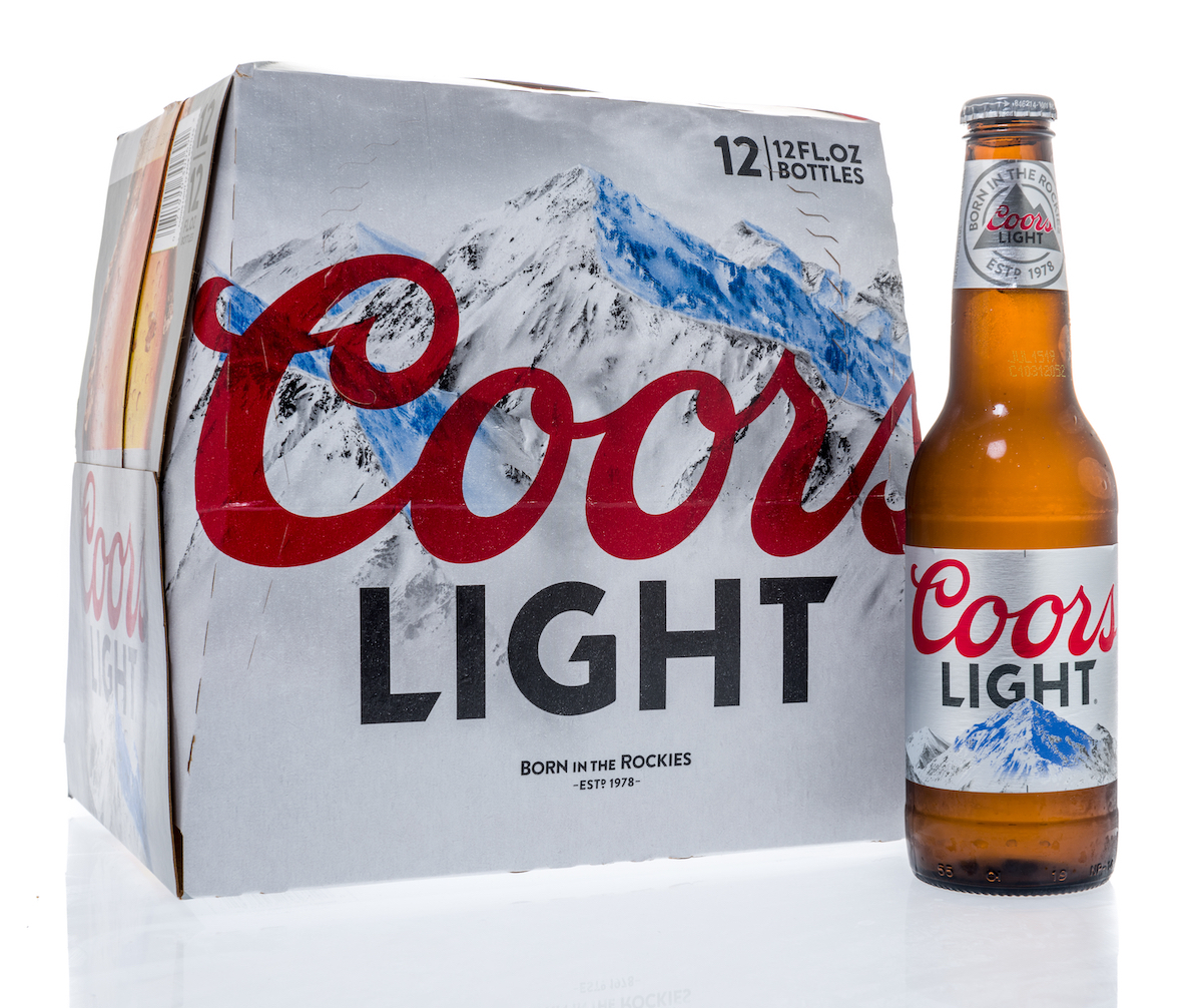 A twelve pack of Coors Light beer bottles on an isolated background.