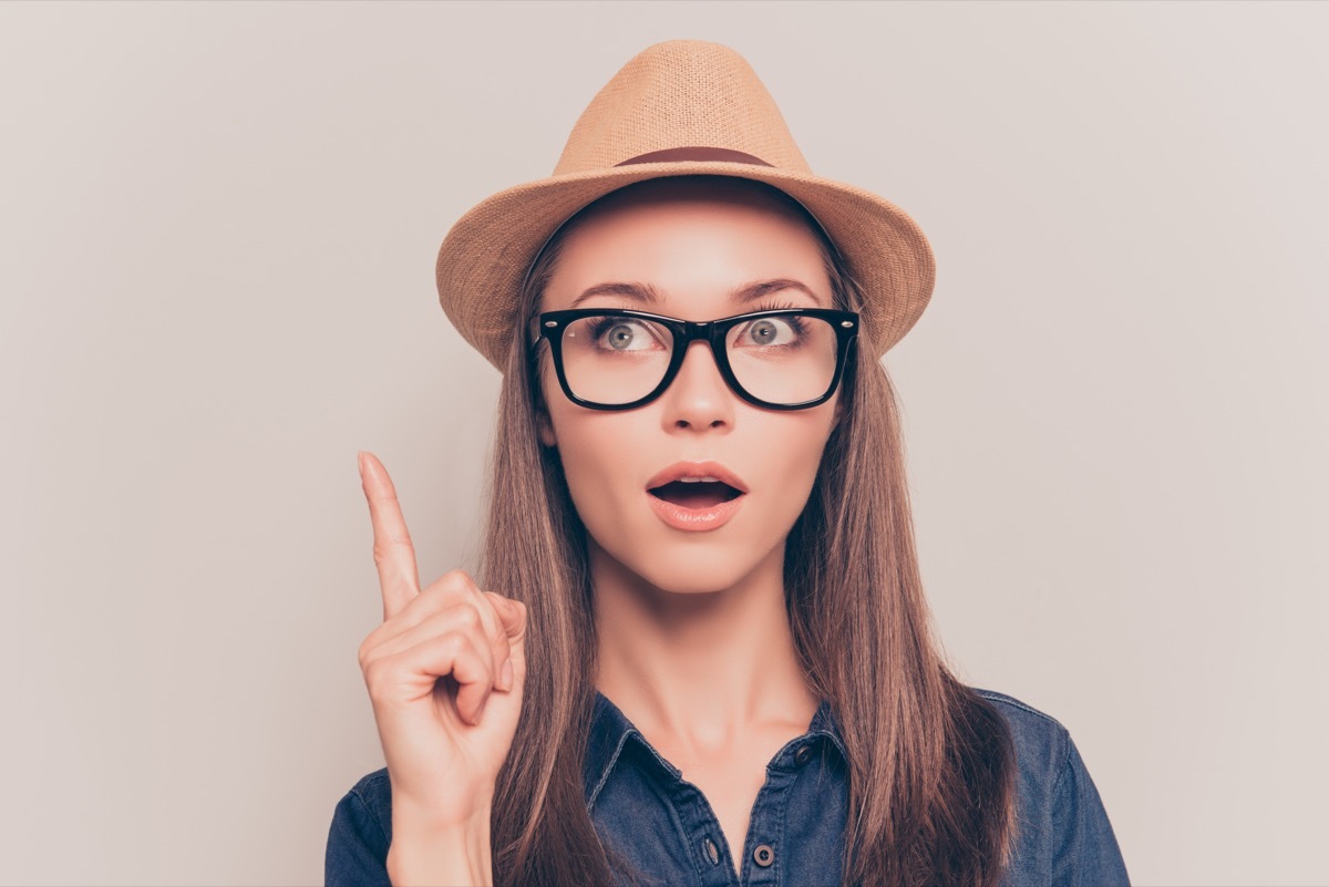 woman wearing a straw hat and black glasses