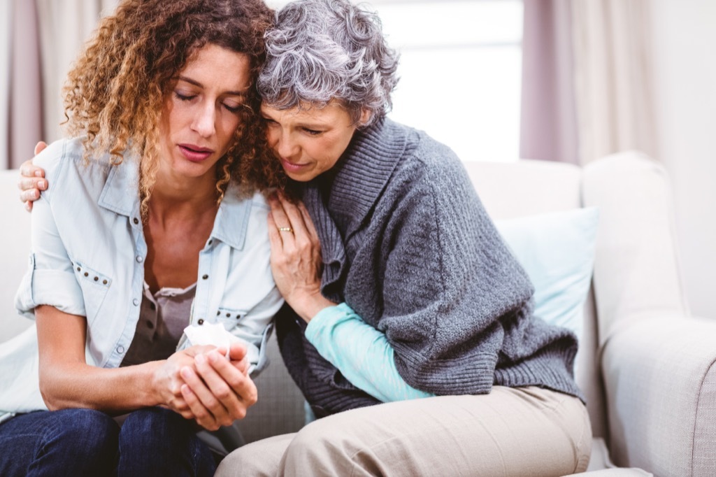 mom comforting grown daughter