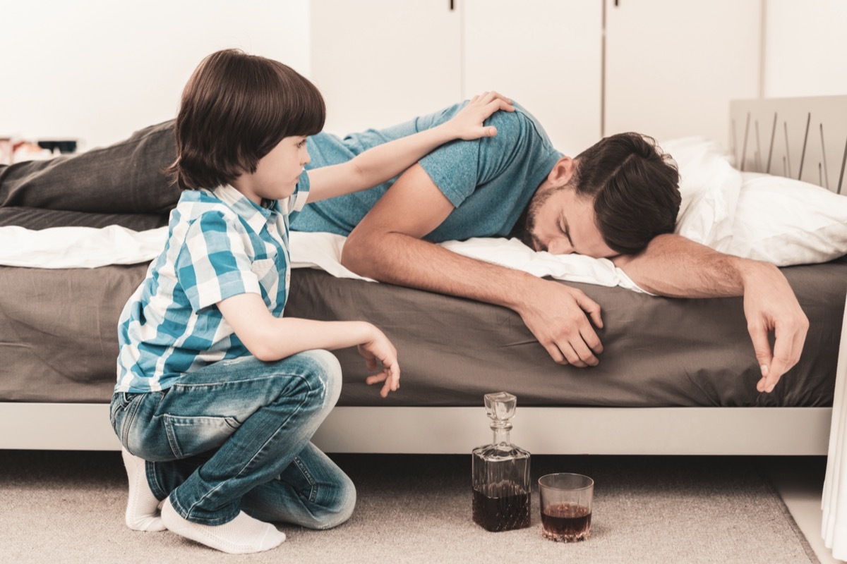 Little Boy Sitting in Room with Drunken Father