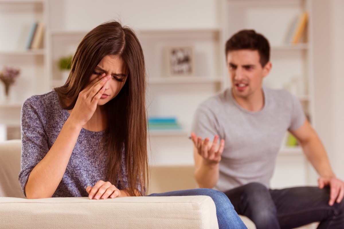 Woman crying as she fights with her partner.