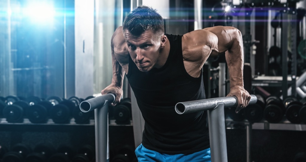 man dips gym exercise grow muscle