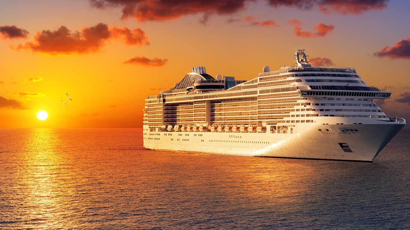 cruise ship sailing into the sunset