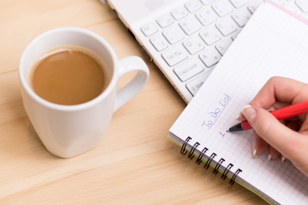 Woman being productive and writing a to-do list.