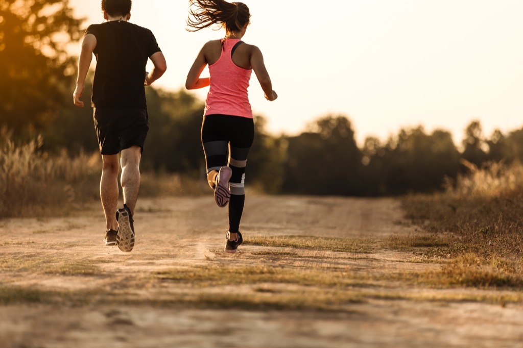 a couple running outdoors in the fall