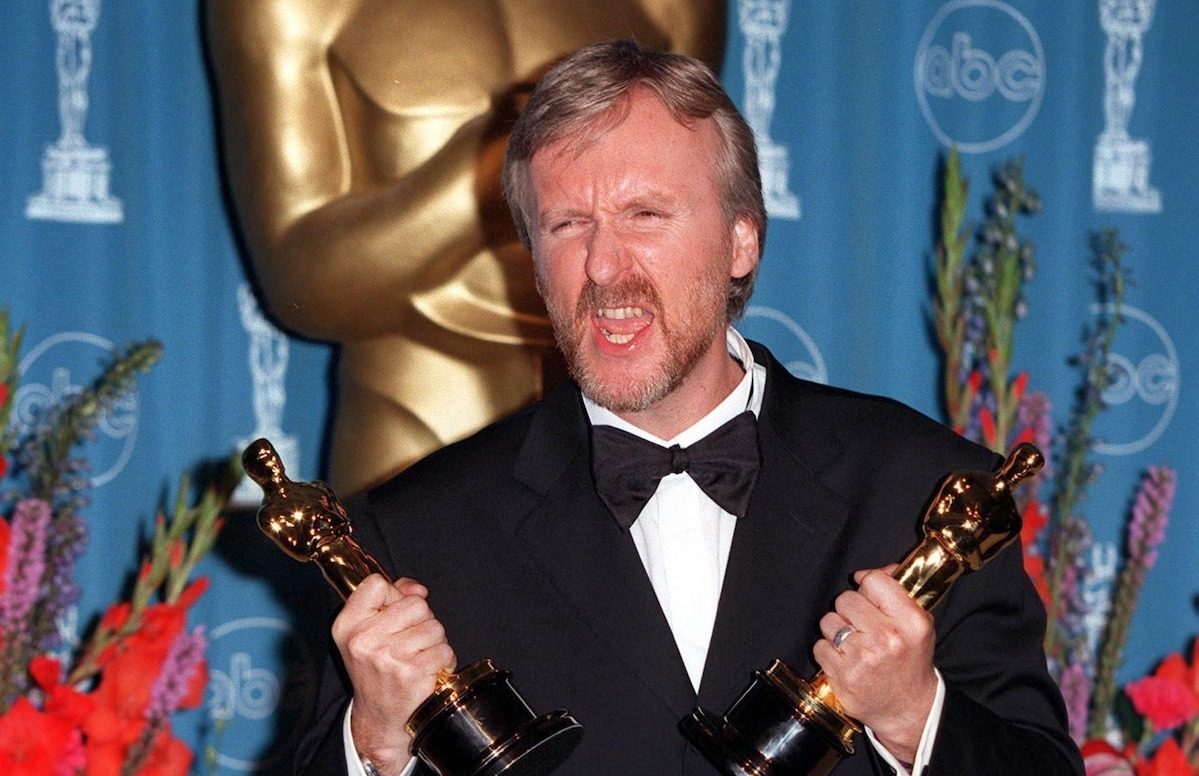 James Cameron holding two Oscars at the 1998 Academy Awards