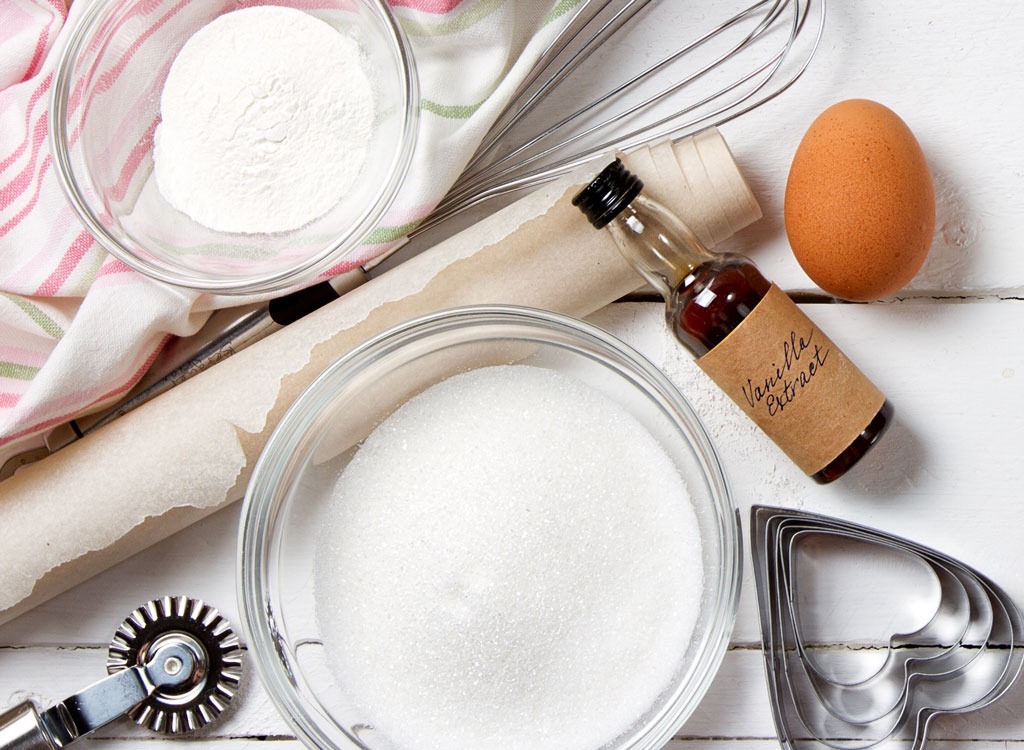 bowl of vanilla extract with rolling pin and cookie cutter