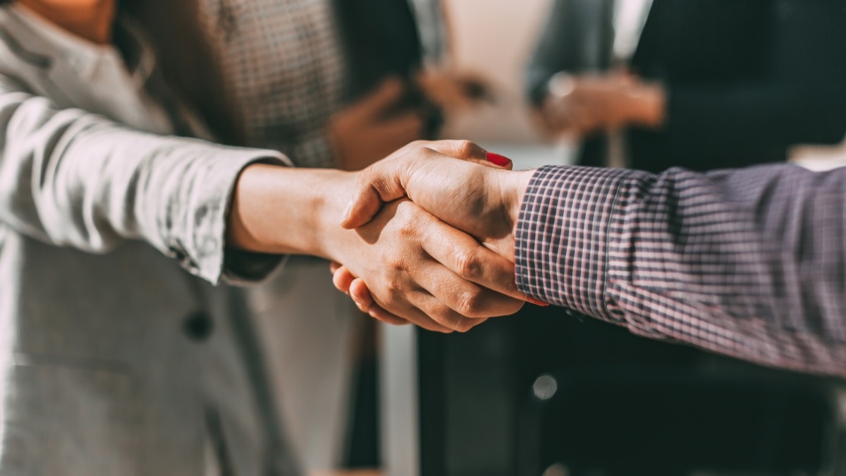 close up of two people shaking hands