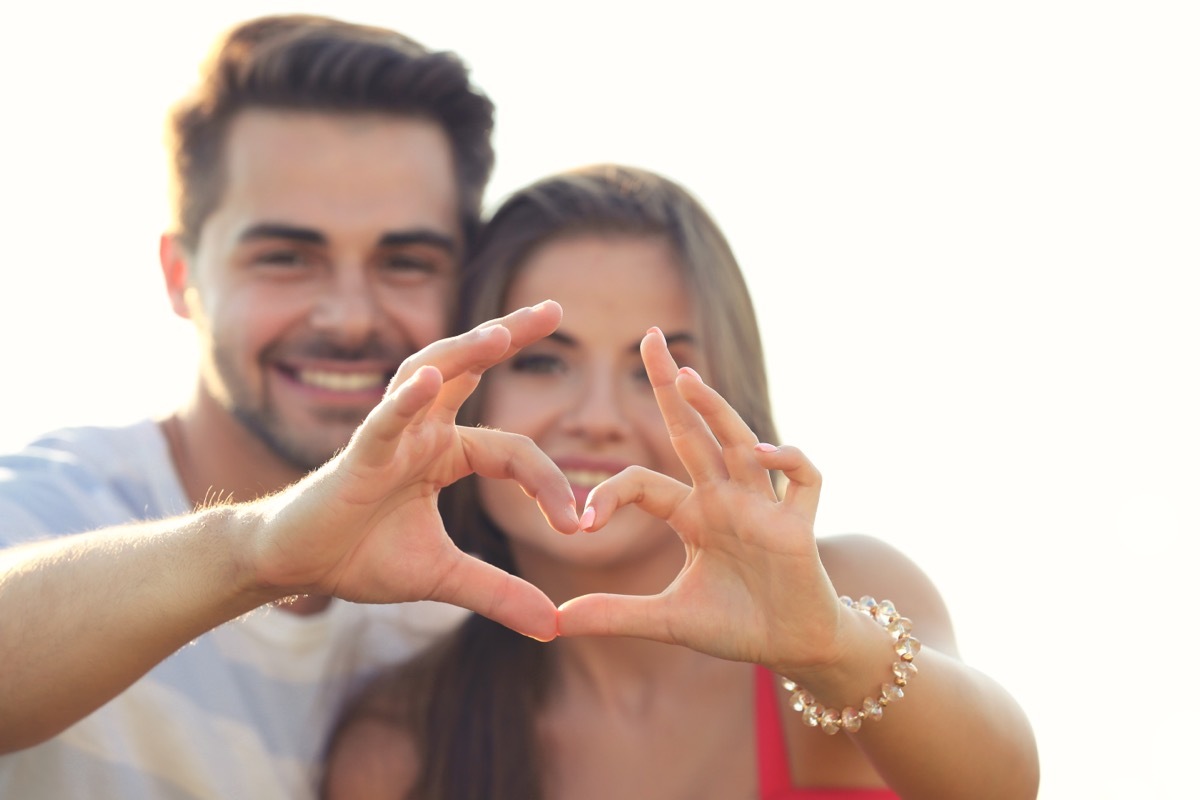 Happy Couple Making Heart with Hands