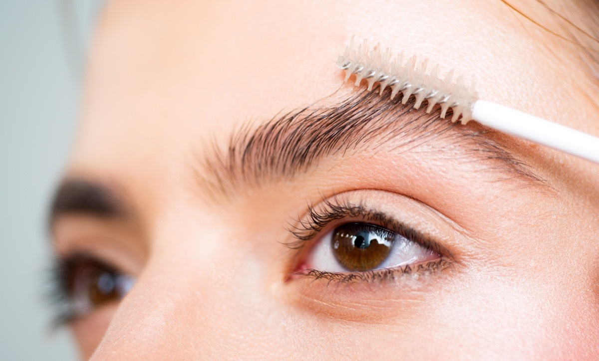 closeup of woman using an eyebrow brush