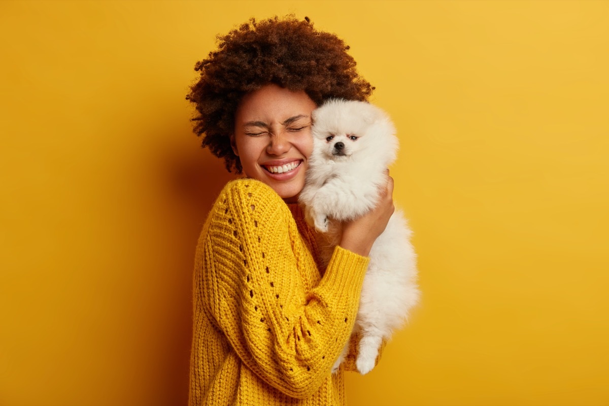 Woman hugging small dog