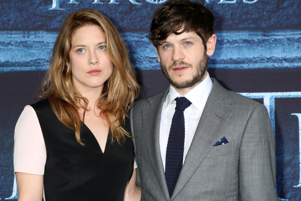 Actor Iwan Rheon stands with Zoe Grisedale on the red carpet