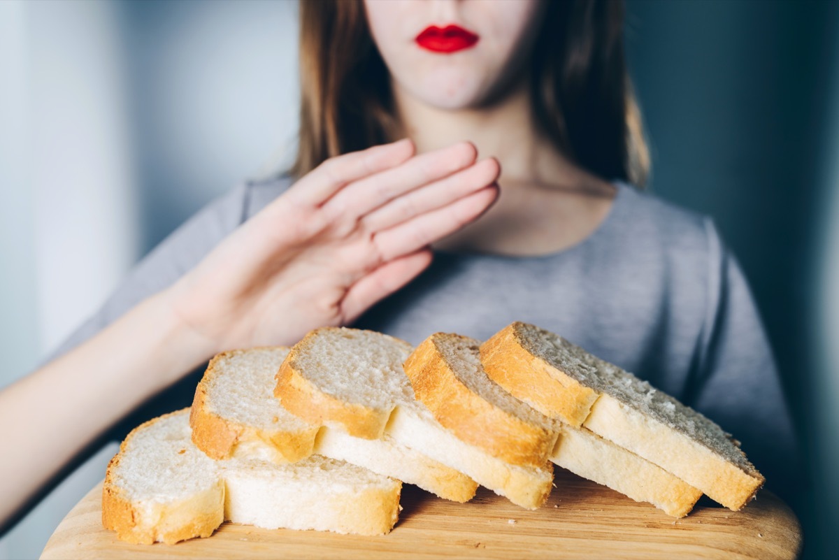 Woman refuses to eat white bread. Shallow depth of field