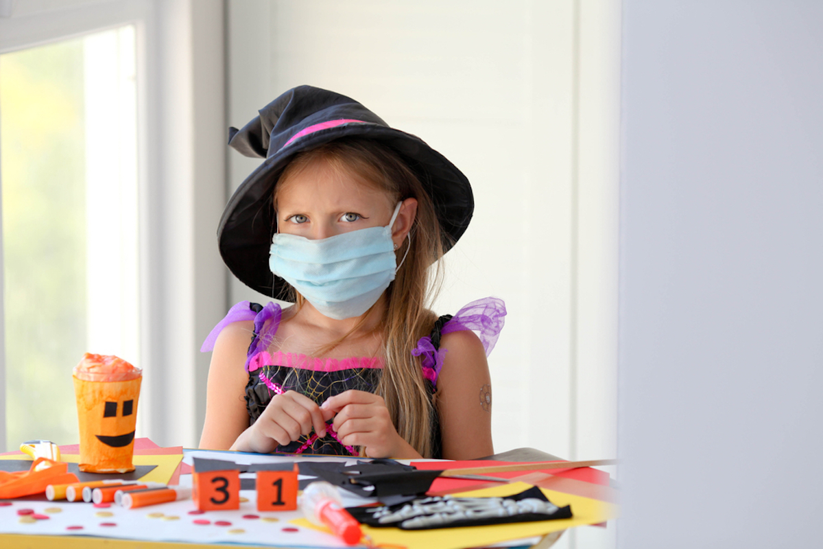 young girl wearing covid mask dressed up for halloween