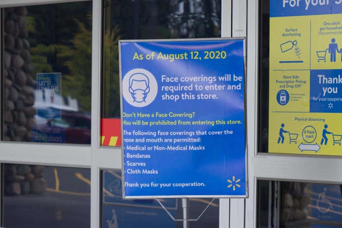 mask sign hanging in walmart store entry