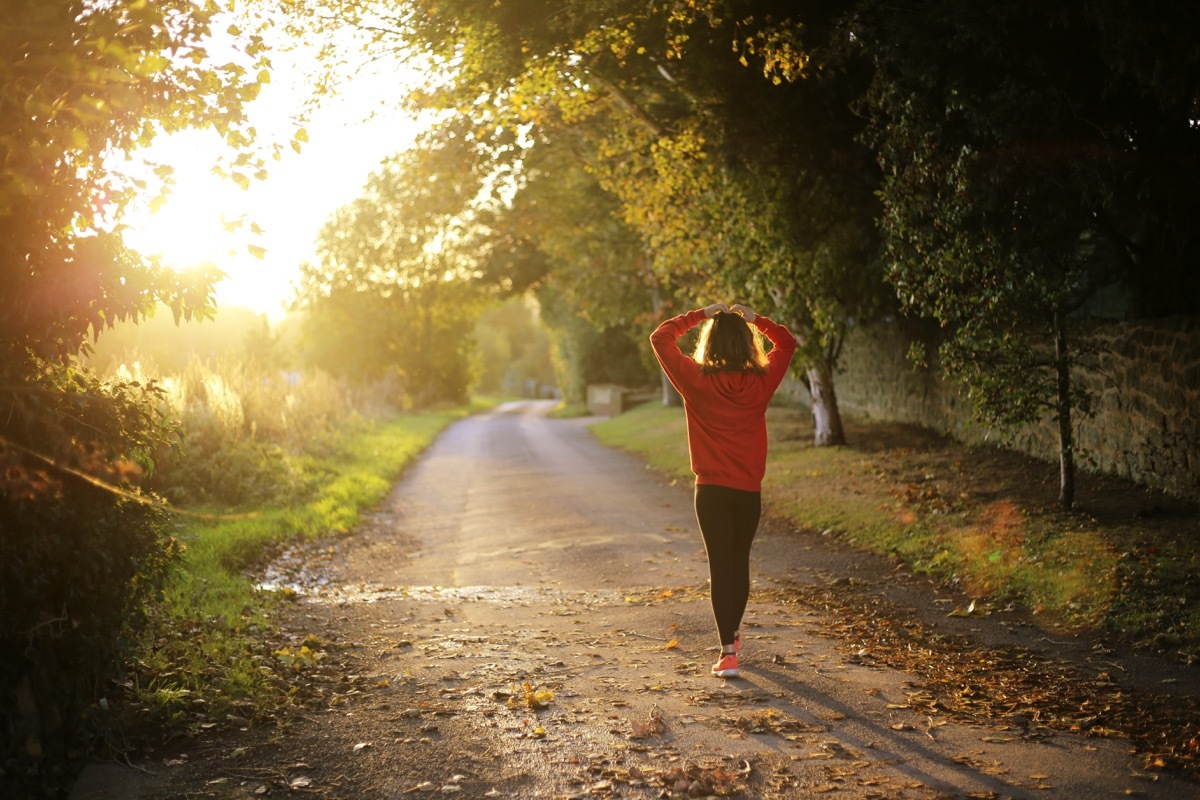 Woman running outside in the fall fall weather health